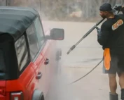 detailing vs car wash with an employee washing a car