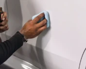 Waxing your car with a soft finish cloth.